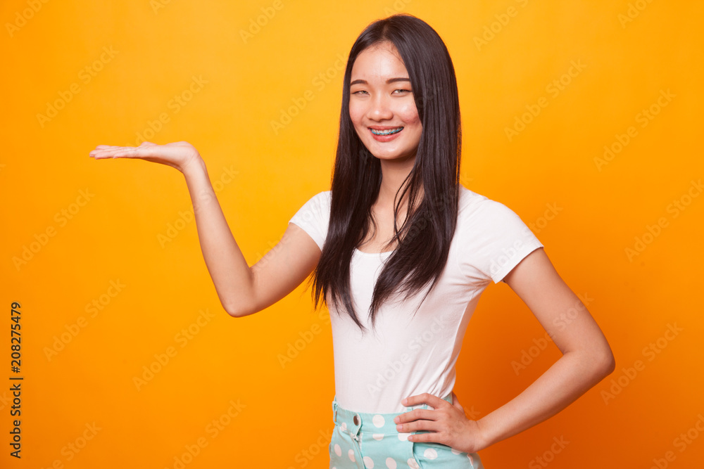 Young Asian woman present with her hand. Young Asian woman present with her hand.