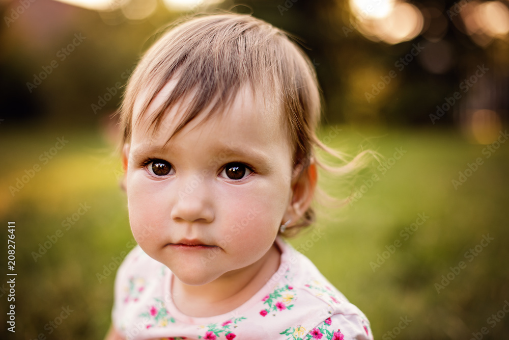 very cute small girl playing outdoors in a park very cute small girl playing outdoors in a park