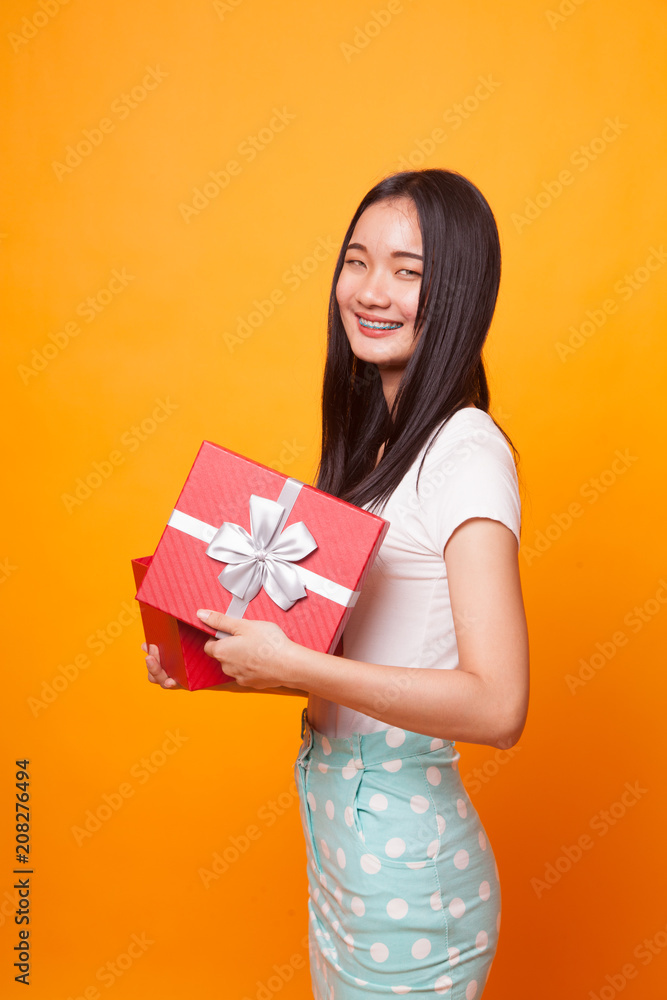 Young Asian woman open a gift box. Young Asian woman open a gift box.
