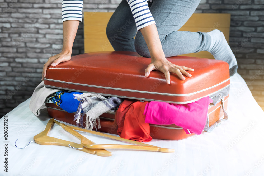 Young Woman Packing Clothes into Travel Bag Stock Image - Image of