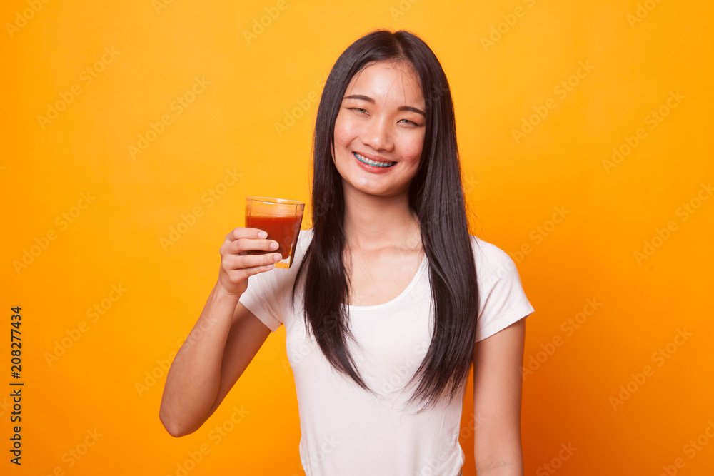Young Asian woman drink tomato juice. Young Asian woman drink tomato juice.