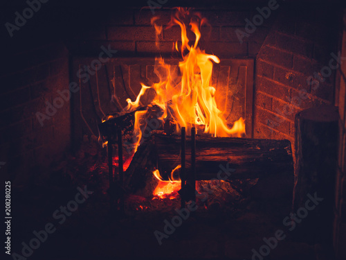 Burning wood in fireplace in a countryside house