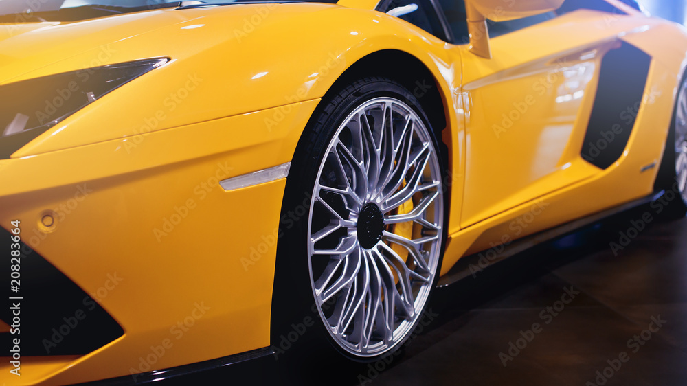 Wheels of a modern sport car. The lights of the yellow car. Modern Car ...