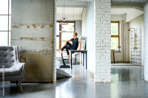 A young handsome Dancer relaxing in a loft style apartment