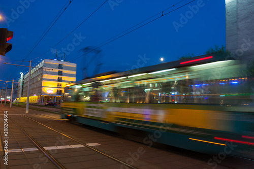 The motion of a blurred tram at dusk.