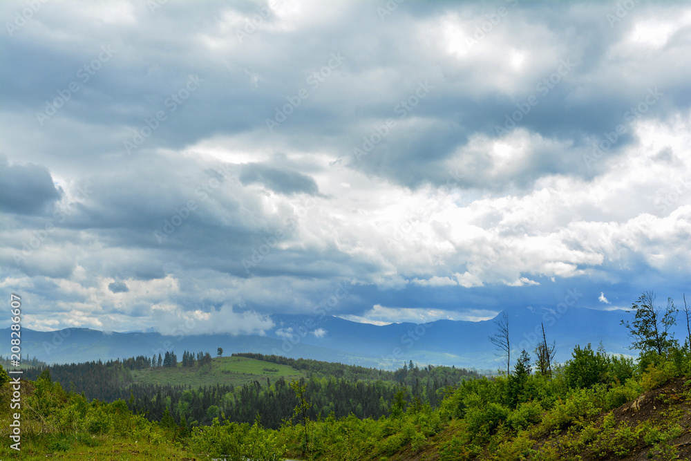 Mountain landscape - cloudy day, clouds and clouds. Against the background - Ukrainian mountain Goverla in the clouds.
