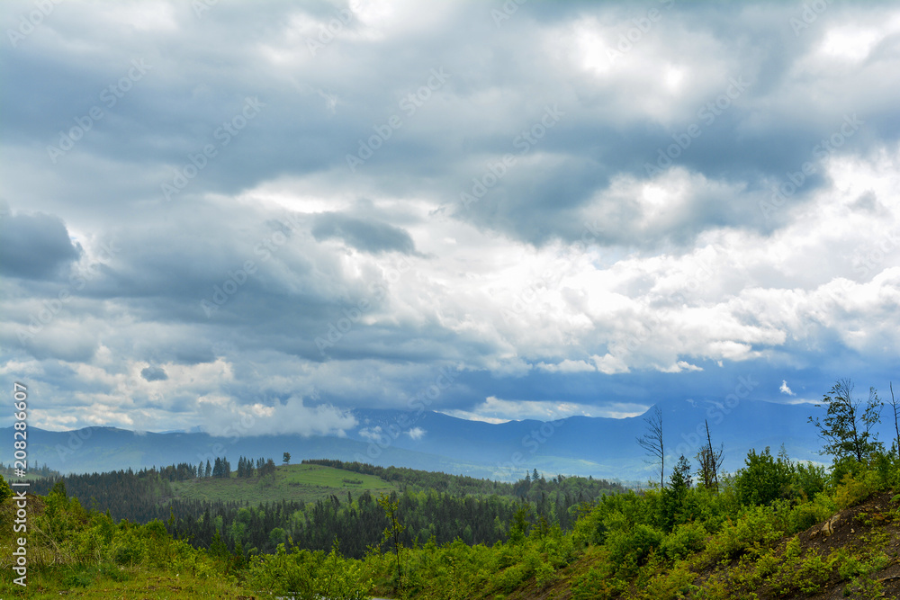 Mountain landscape - cloudy day, clouds and clouds. Against the background - Ukrainian mountain Goverla in the clouds. Mountain landscape - cloudy day, clouds and clouds. Against the background - Ukrainian mountain Goverla in the clouds.