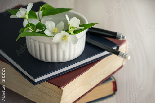 Fototapeta Naklejka Na Ścianę i Meble -  Old books, diary and a jasmine flower. 