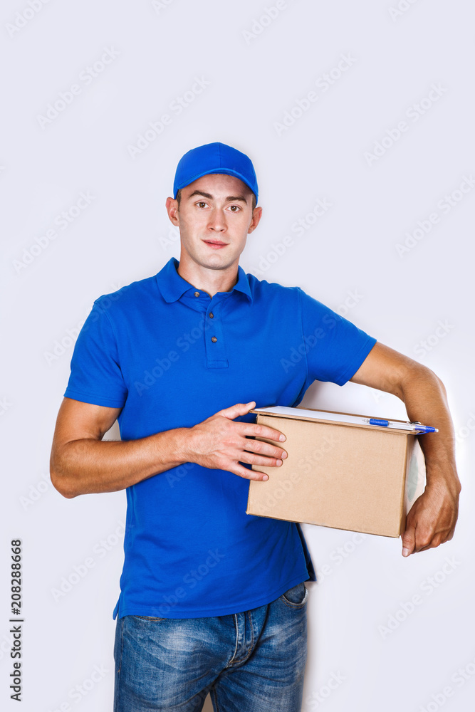 Cheerful delivery man. Happy young courier holding a cardboard box and smiling Cheerful delivery man. Happy young courier holding a cardboard box and smiling