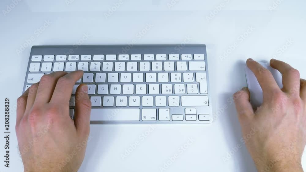 Hands writing on the keyboard and move the mouse Hands writing on the keyboard and move the mouse
