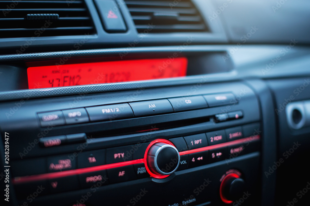 Car radio and air conditioner system. Button on dashboard in modern car panel. Car radio and air conditioner system. Button on dashboard in modern car panel.