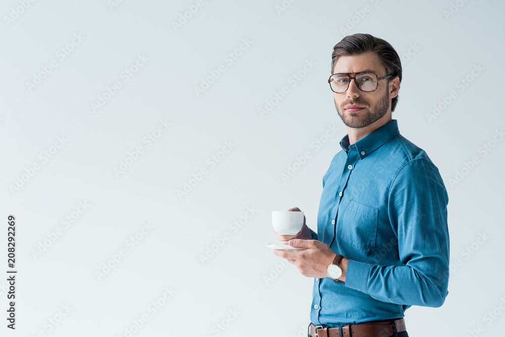 handsome young man with cup of coffee looking at camera isolated on white handsome young man with cup of coffee looking at camera isolated on white