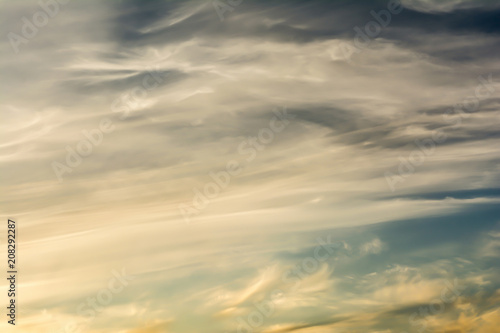 layered clouds at sunset time, dark blue sky, nature abstract background