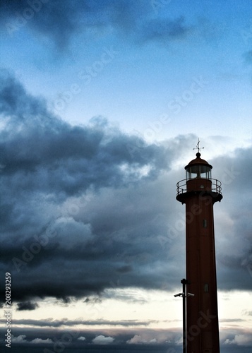 Red lighthouse in the port of Cacilhas village in Lisbon