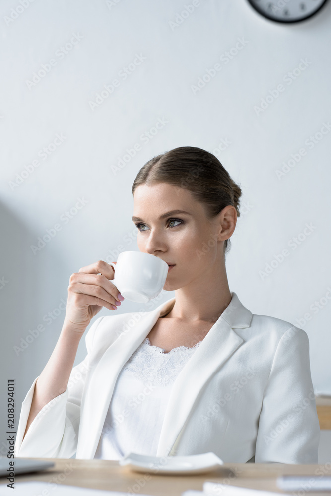 attractive young businesswoman drinking coffee at office attractive young businesswoman drinking coffee at office