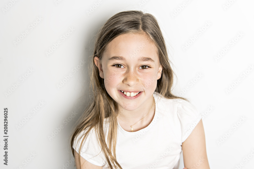 Portrait of cute, confident 9 years old girl, isolated on white