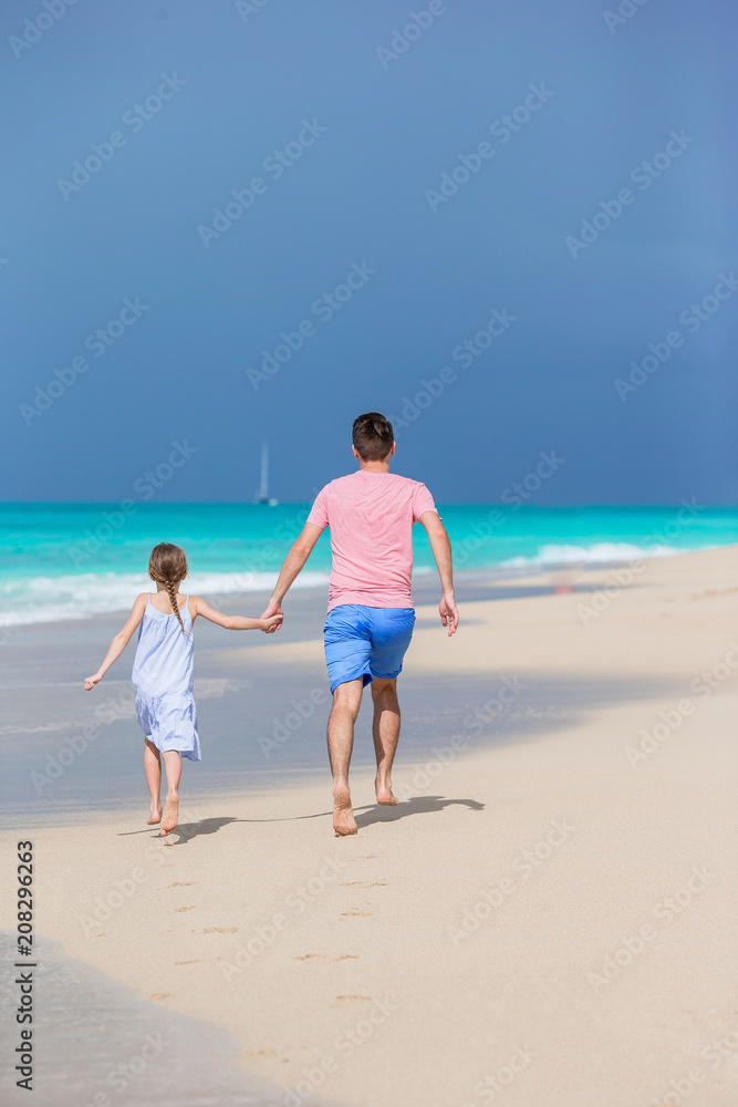 Family at tropical beach walking together in caribbean island Family at tropical beach walking together in caribbean island