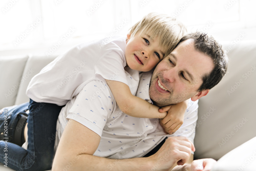 Father and his five years kid on the sofa at home Father and his five years kid on the sofa at home
