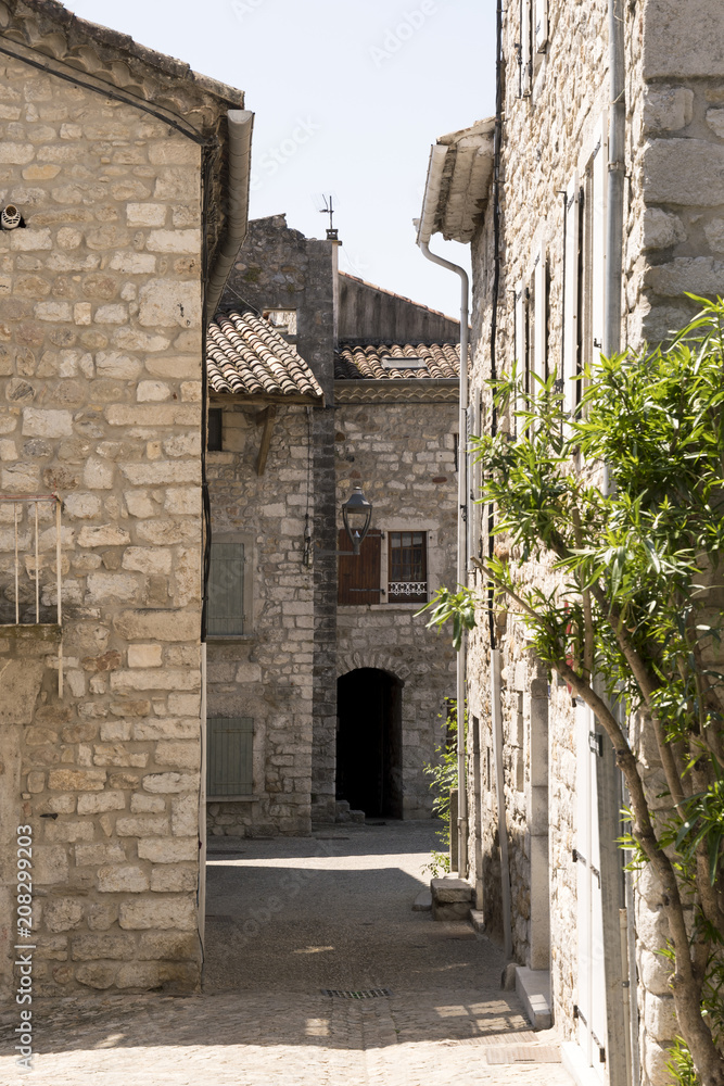 a lane between old stone houses in the old city ruoms of france