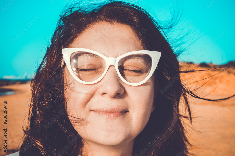 Face of a beautiful woman in sunglasses