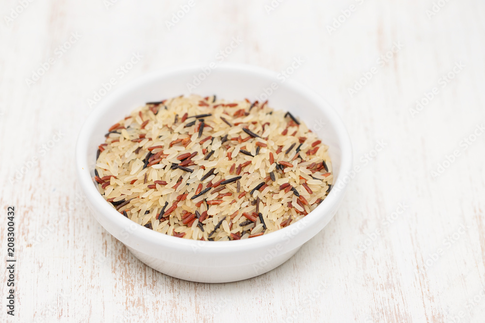 uncooked healthy rice in white bowl