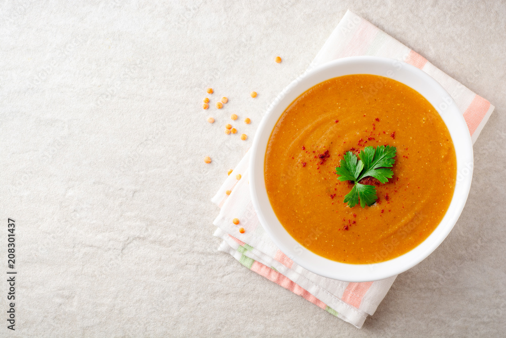 Red lentil cream soup on gray stone background Red lentil cream soup on gray stone background