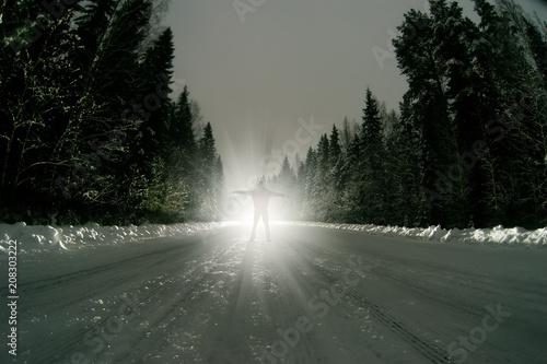 A young guy stay on the road in front of a traveling car. The concept of suicide