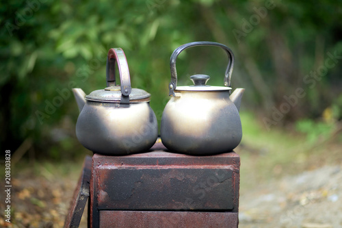 Two stained kegs on the fire stand on the grill