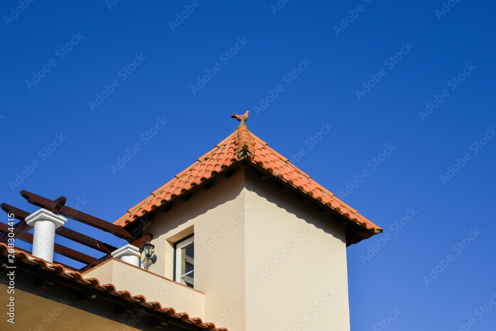 Clay rooster on top of the roof of a house in Algarve, Portugal