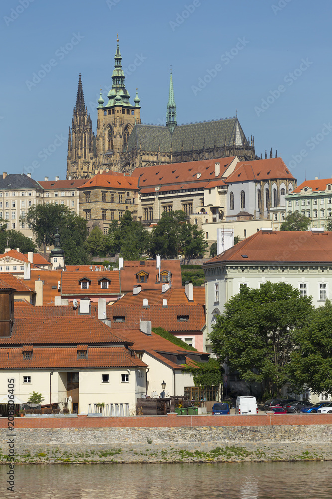 Spring Prague gothic Castle with the Lesser Town above River Vltava in the sunny Day, Czech Republic Spring Prague gothic Castle with the Lesser Town above River Vltava in the sunny Day, Czech Republic