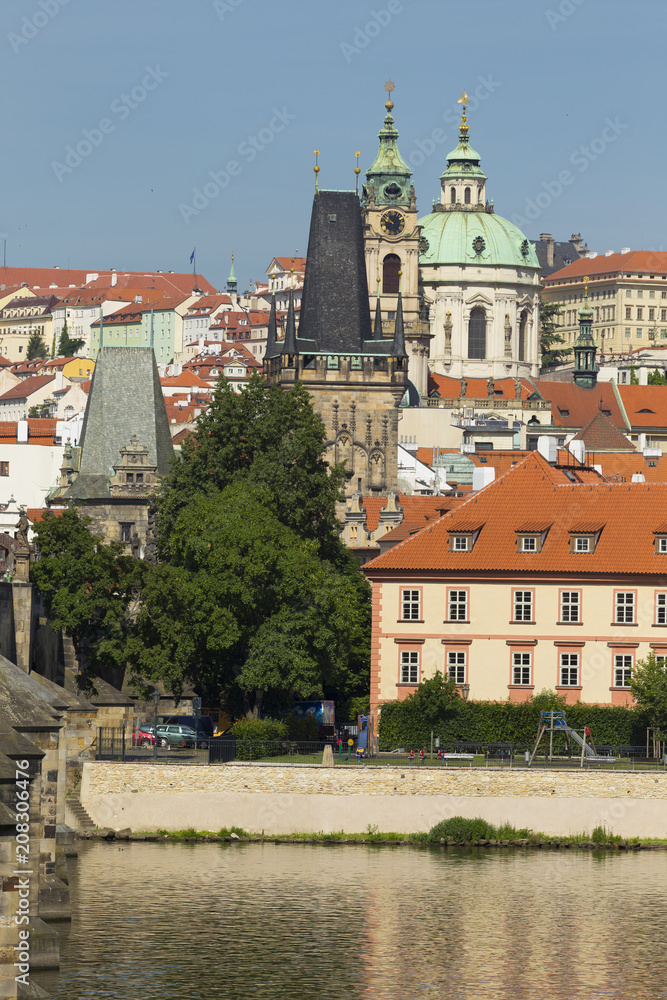 Spring Prague St. Nicholas' Cathedral with the Lesser Town above River Vltava in the sunny Day, Czech Republic