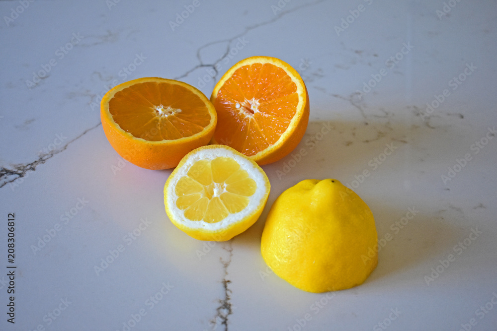Orange and Lemon Citrus Slices on White Marble Background Orange and Lemon Citrus Slices on White Marble Background