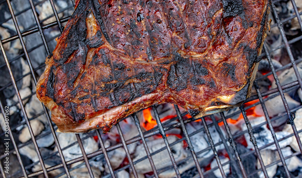 Close-up of a grilled beef rib on a barbecue grill