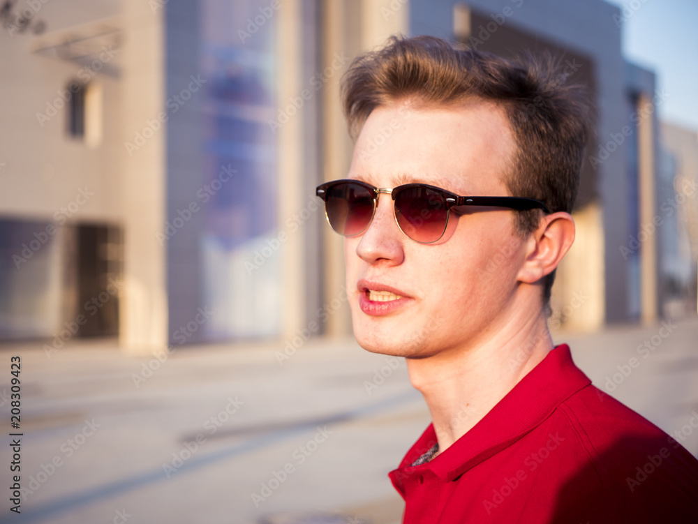 close up brutal young male in casual clothes portrait walking in the city close up brutal young male in casual clothes portrait walking in the city