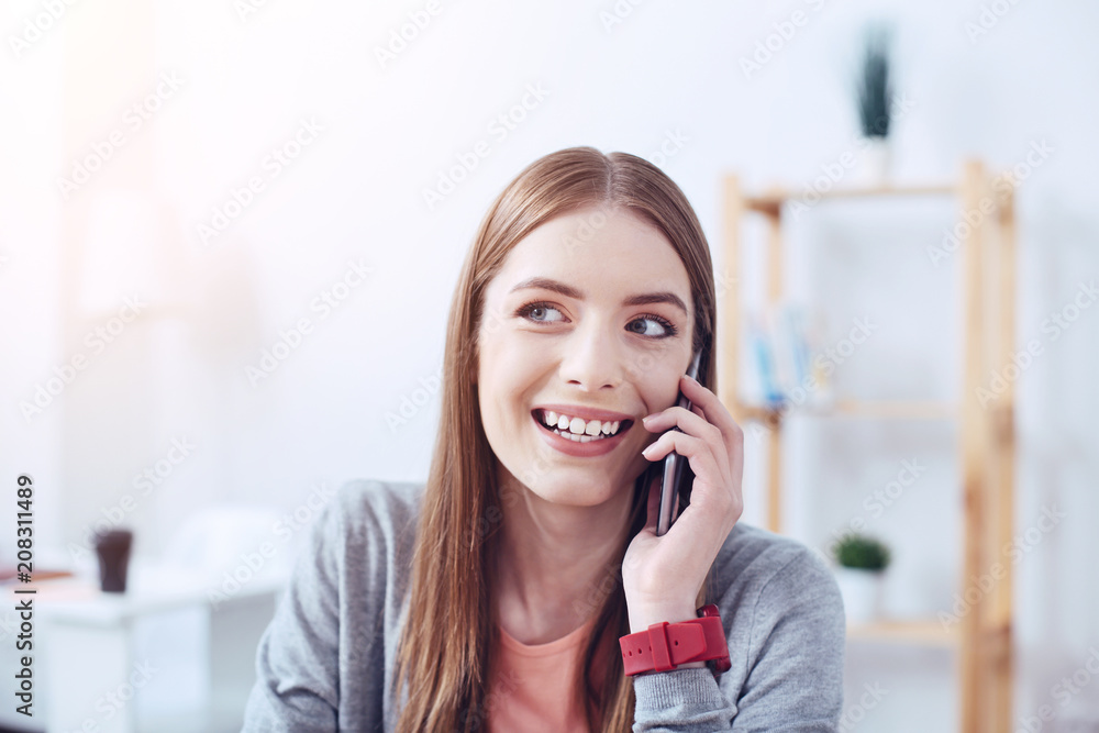 Joyful mood. Young worker expressing positivity and being in office while having friendly conversation Joyful mood. Young worker expressing positivity and being in office while having friendly conversation
