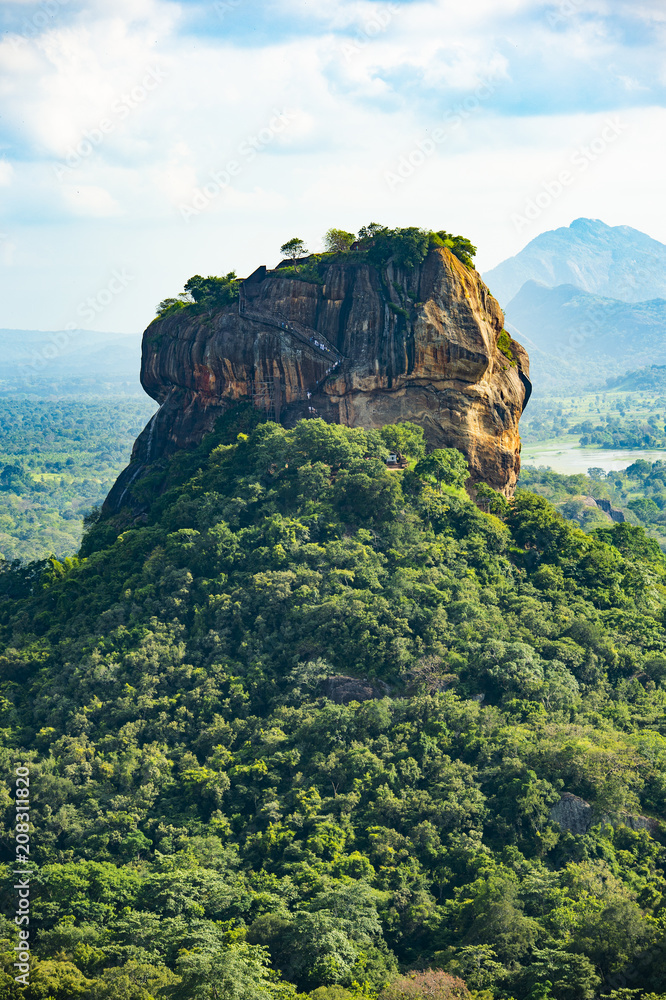 Spectacular view of the Lion rock surrounded by green rich vegetation. Picture taken from Pidurangala Rock in Sigiriya, Sri Lanka.