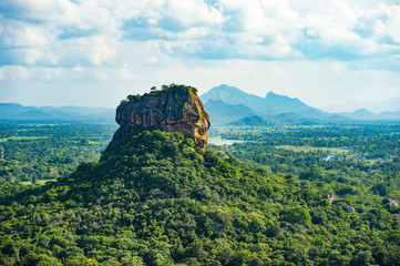 Spectacular view of the Lion rock surrounded by green rich vegetation. Picture taken from Pidurangala Rock in Sigiriya, Sri Lanka.