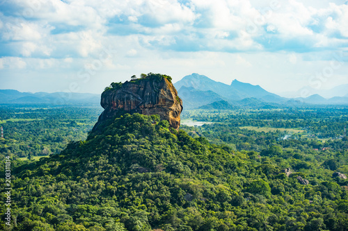 Spectacular view of the Lion rock surrounded by green rich vegetation. Picture taken from Pidurangala Rock in Sigiriya, Sri Lanka.