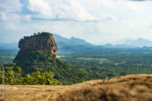 Spectacular view of the Lion rock surrounded by green rich vegetation. Picture taken from Pidurangala Rock in Sigiriya, Sri Lanka.