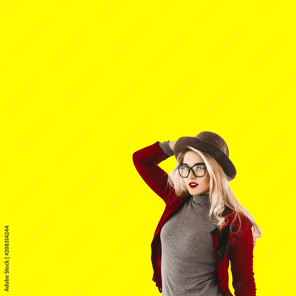 beautiful girl. yellow background. hat on the head. stylish glasses with a transparent frame. red lipstick on the lips. beautiful girl. yellow background. hat on the head. stylish glasses with a transparent frame. red lipstick on the lips.