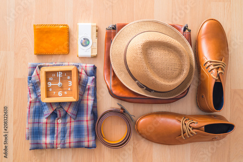 flat lay of men's casual fashion on brown wooden floor background
