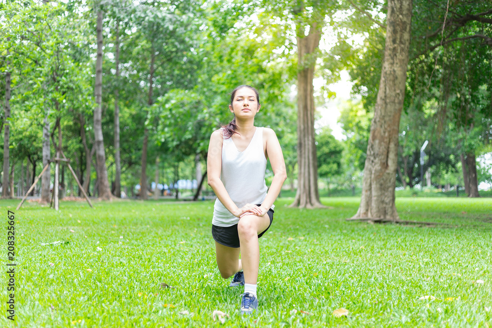 A young woman getting ready for athletic and fitness training outdoors. Healthy lifestyle concept with sunrise early morning. A young woman getting ready for athletic and fitness training outdoors. Healthy lifestyle concept with sunrise early morning.