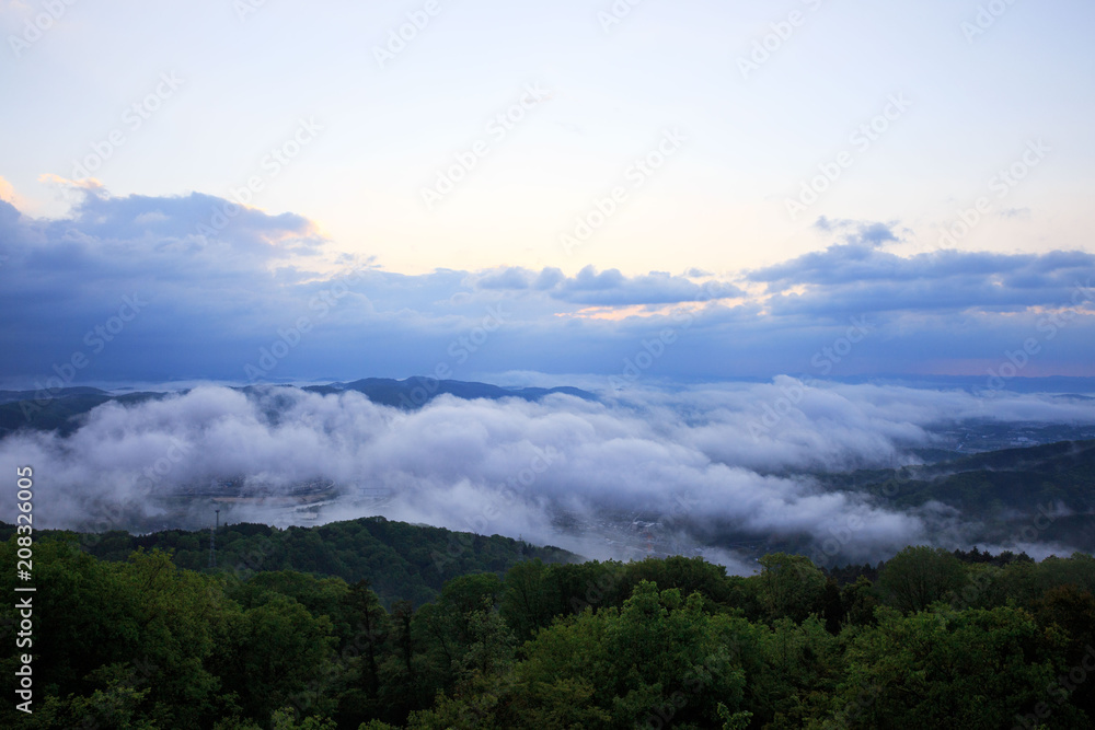 Low fog clinging to valley from mountain viewpoint Low fog clinging to valley from mountain viewpoint