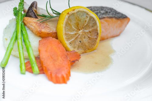 Grilled salmon steak slices on a white plate