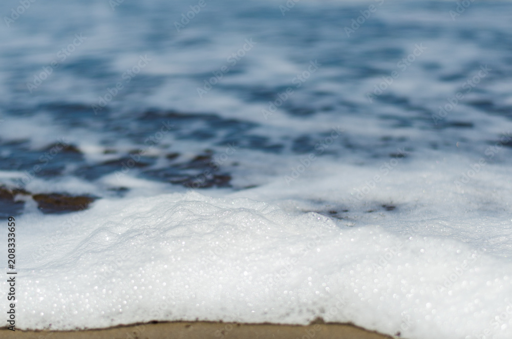 Obraz premium Ocean foam on the sand