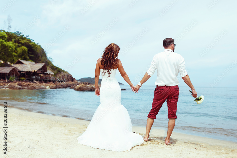 Wedding couple on the beach. Back veiw Wedding couple on the beach. Back veiw