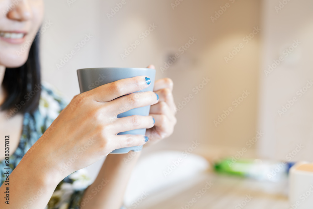 hands holding hot cup of coffee or tea in morning sunlight hands holding hot cup of coffee or tea in morning sunlight