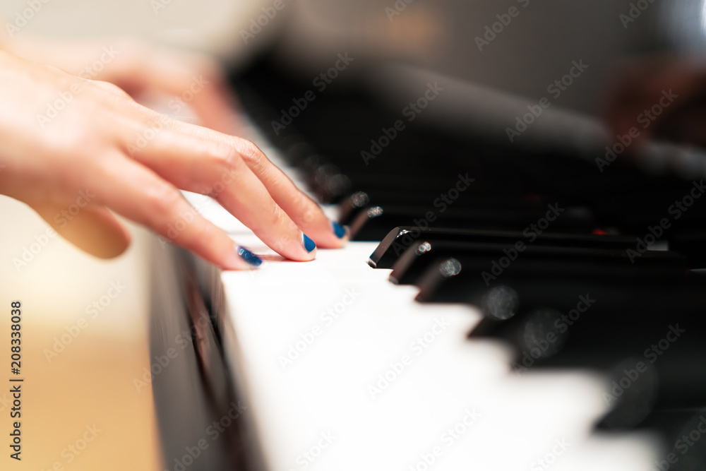 Obraz premium women hand on classic Piano keyboard closeup, music instruments concept