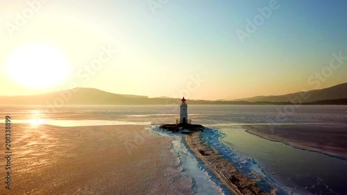 Aerial winter view of the Tokarevskiy lighthouse - one of the oldest lighthouses in the Far East, still an important navigational structure and popular attractions of Vladivostok city, Russia. photo