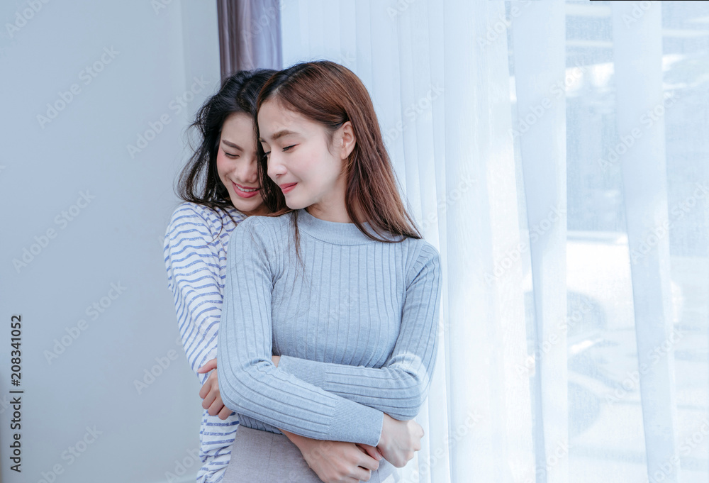 Same sex asian lesbian couple lover embrace in the bedroom at morning happiness feeling, LGBT sexuality female hug living together at home. Same sex asian lesbian couple lover embrace in the bedroom at morning happiness feeling, LGBT sexuality female hug living together at home.